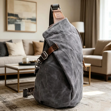 Textured Teardrop Sling Pack With Brown Accent Buckle Strips And Curved Full Edge Zip Closure